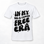 A white short-sleeve crewneck t-shirt with a bold black graphic text reading 'IN MY BRA & CANCER FREE ERA' decorated with small black star accents, displayed on a clean white background.