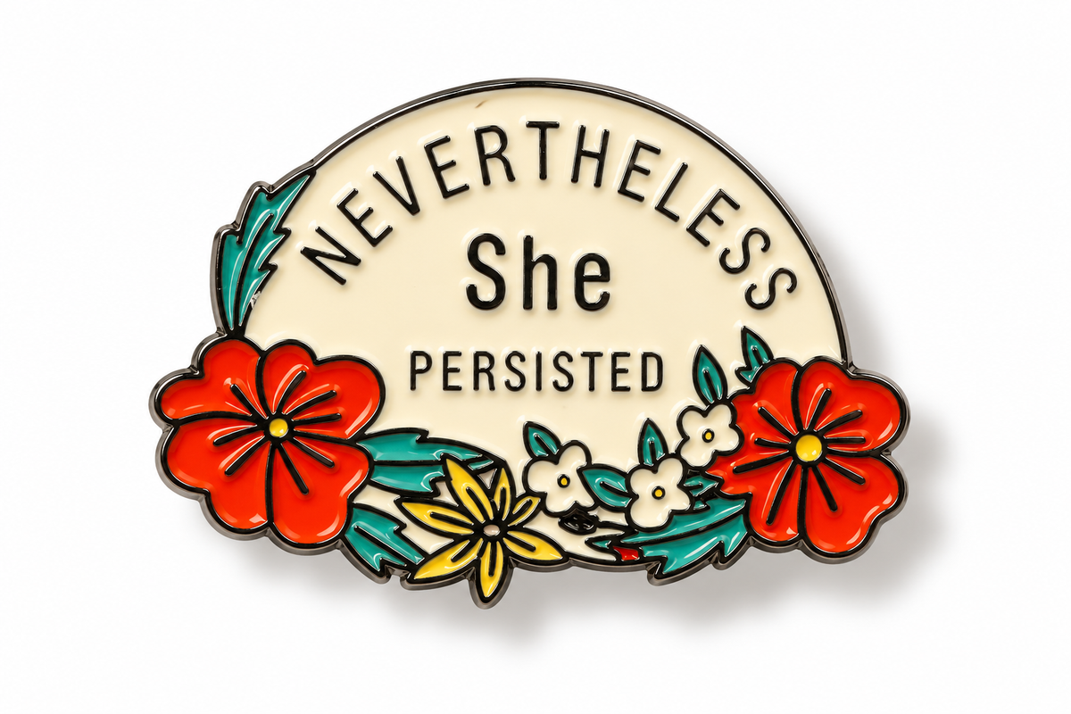 A decorative enamel pin shaped like a semi-circle with the words 'NEVERTHELESS She PERSISTED' in black lettering on a cream background, surrounded by red, yellow, and white flowers with green leaves on a white studio background.