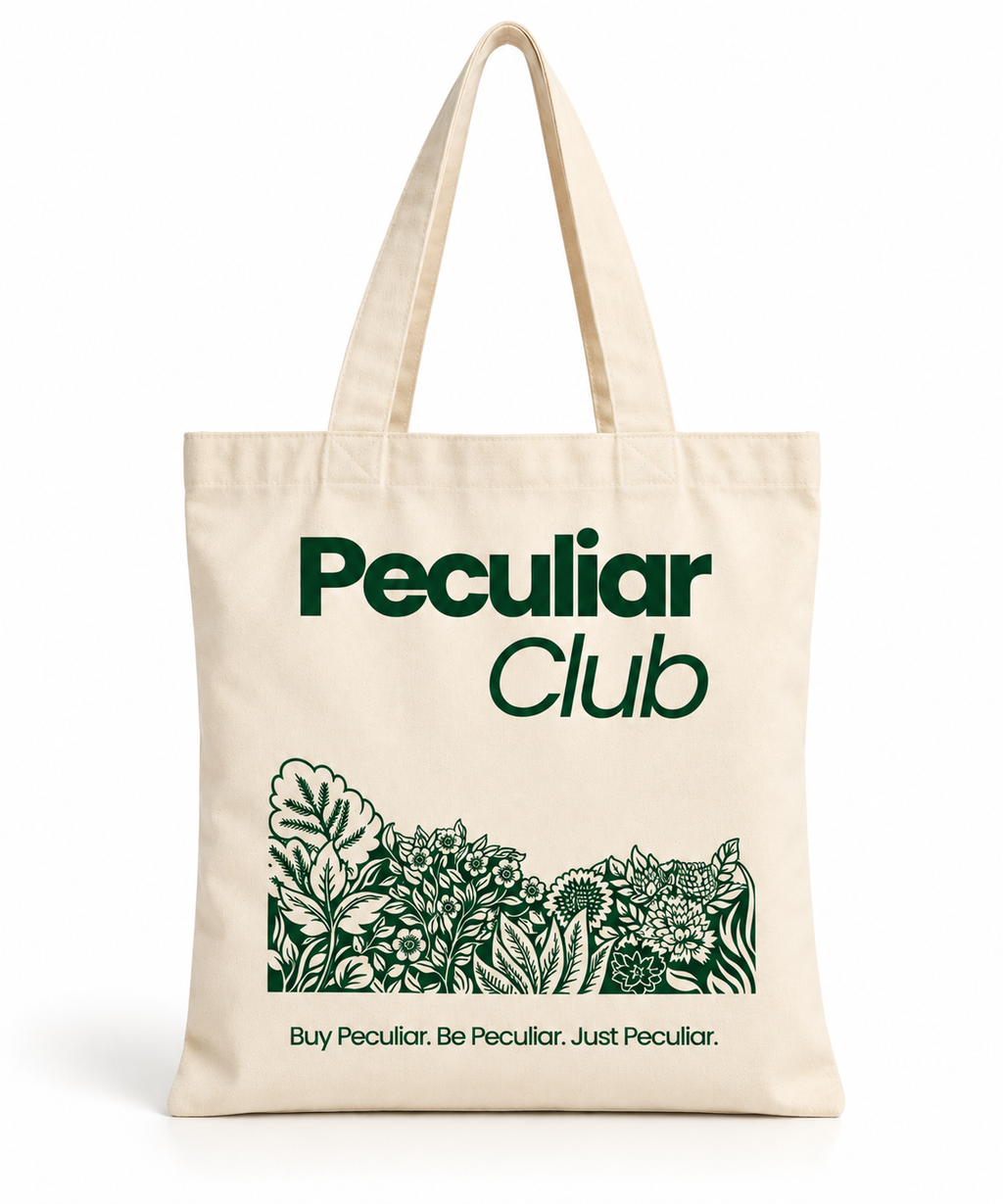 A natural canvas tote bag with dark green printed text reading 'Peculiar Club' and a botanical line-art illustration, shown on a clean white background.