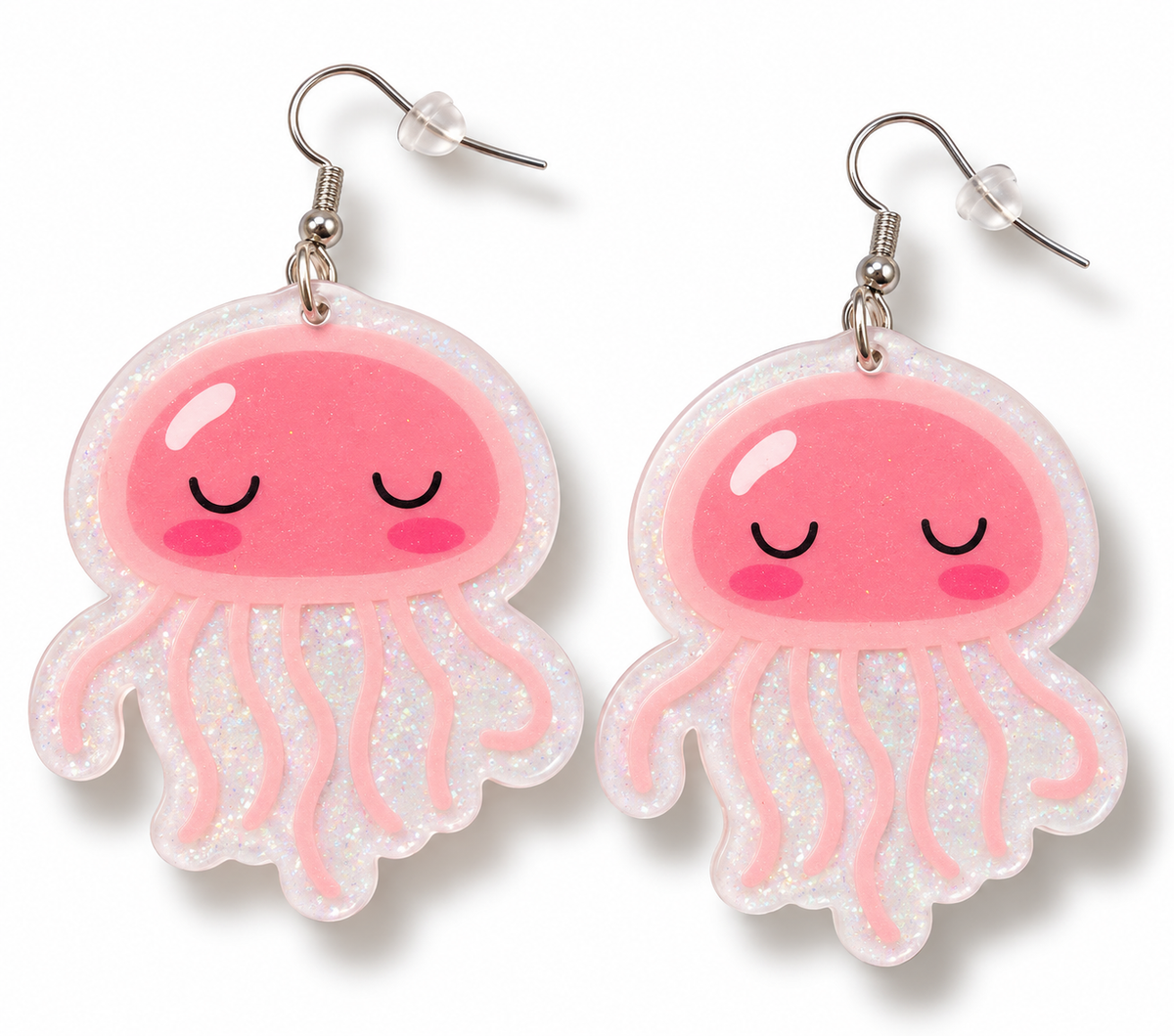 A pair of jellyfish-shaped dangling earrings with glittery white translucent bodies, pink smiling faces, and silver fishhook ear wires on a white background.