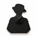 The back of a novelty pin shaped like a silhouette of a person wearing a top hat, with a central circular clasp, shown on a plain white background.