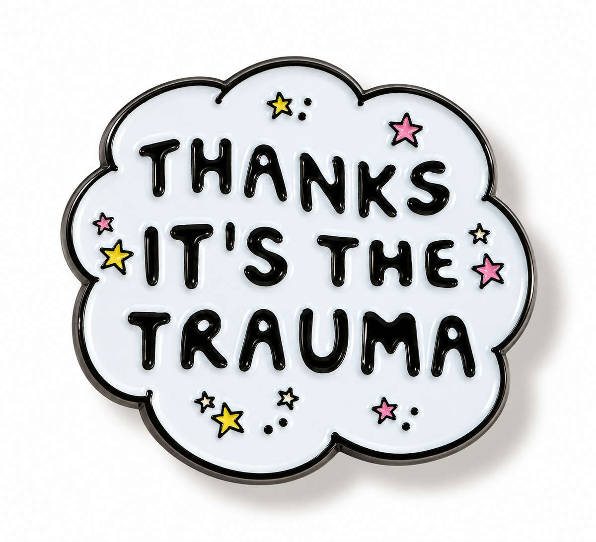 A cloud-shaped enamel pin with a white face, black border, and black text reading 'THANKS IT'S THE TRAUMA' surrounded by small colorful stars on a white background.