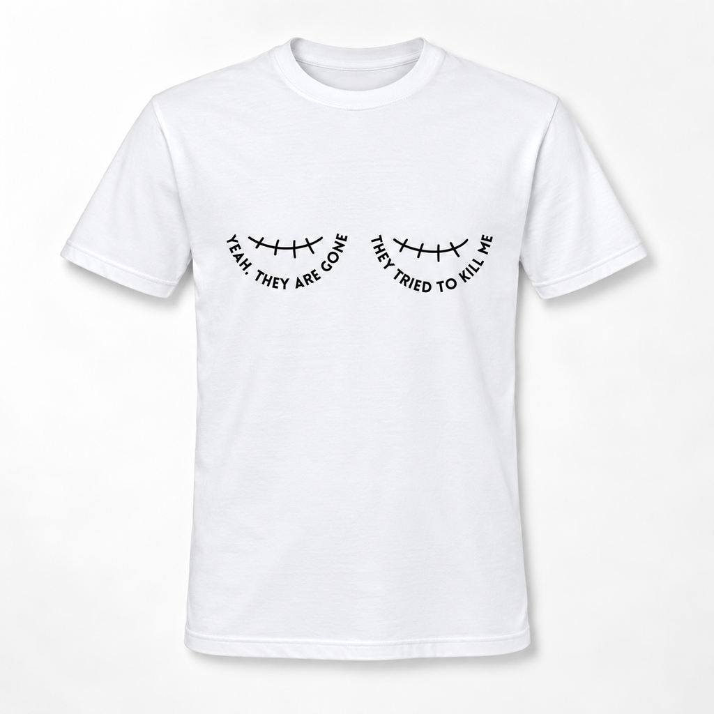 A white short-sleeve crewneck t-shirt with a black graphic of a double mastectomy scar and the text 'YEAH THEY ARE GONE' and 'THEY TRIED TO KILL ME' printed on the chest.