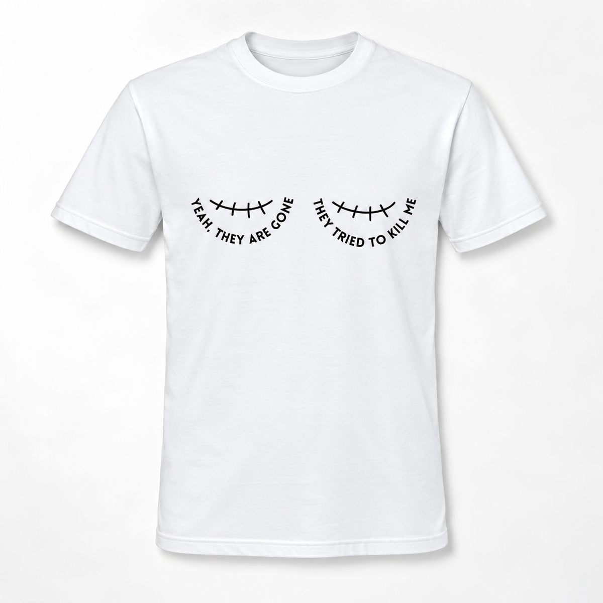 A white short-sleeve crewneck t-shirt with a black graphic of a double mastectomy scar and the text 'YEAH THEY ARE GONE' and 'THEY TRIED TO KILL ME' printed on the chest.