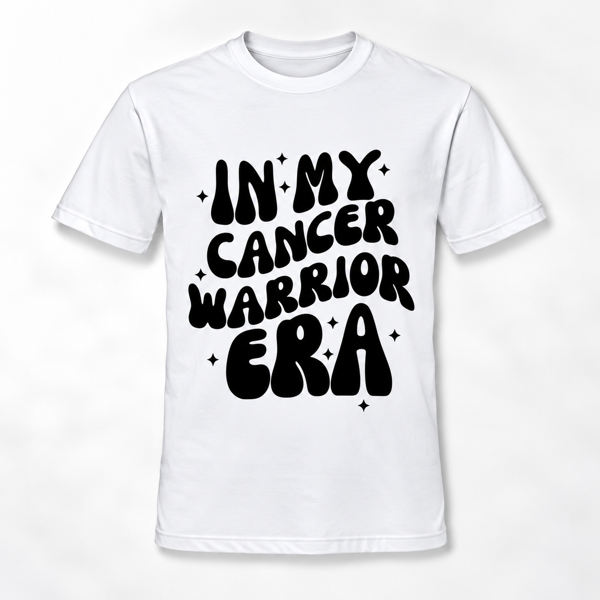 A white short-sleeve crewneck t-shirt with a bold black retro-style graphic on the front that reads 'IN MY CANCER WARRIOR ERA' surrounded by small star accents.