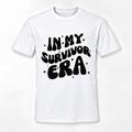 A white short-sleeve crewneck t-shirt with a black retro-style graphic text reading 'IN MY SURVIVOR ERA' surrounded by small star accents, displayed on a clean white background.